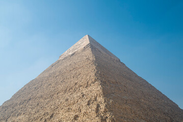 Fototapeta na wymiar Landscape of the pyramids in the desert with blue sky in Giza, Egypt 