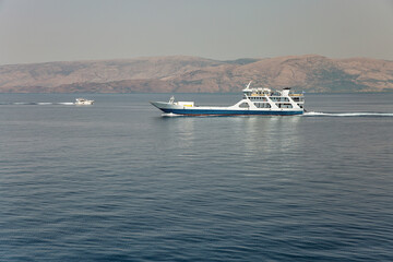 Ferry ship sails in distance off the coast of Greece