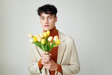 portrait of a young man bouquet of flowers romance fashion date isolated background unaltered