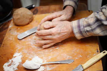 senior man making traditional gingerbread dogh at home
