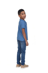 rear view of boy turned and looking at camera on white background