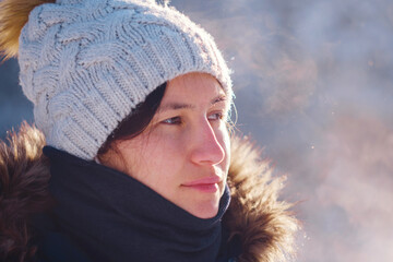 Happy Asian woman walking in winter snow forest. Cold weather hat and warm coat. idea and concept of healthy active lifestyle and good mood in any weather