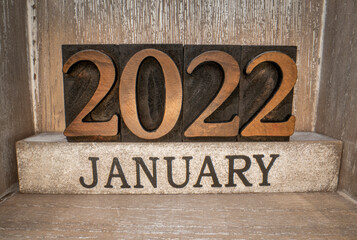 2022 January typography in vintage letterpress wood type inside grunge wooden box, low angle macro...