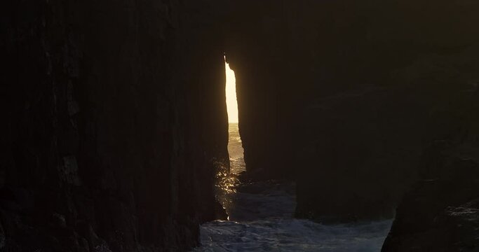 View Through The Zawn Pyg Rock Arch In Nanjizal Beach At Sunset In St Levan, Cornwall, UK. - wide shot