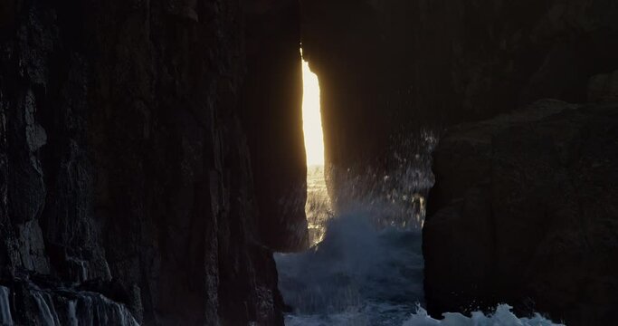 Ocean Waves Crashing Against Zawn Pyg Rock Arch In Nanjizal Beach, Cornwall, United Kingdom. - static