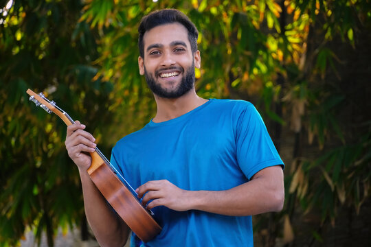 boy with ukulele a musical instrument Handsome Indian musician image