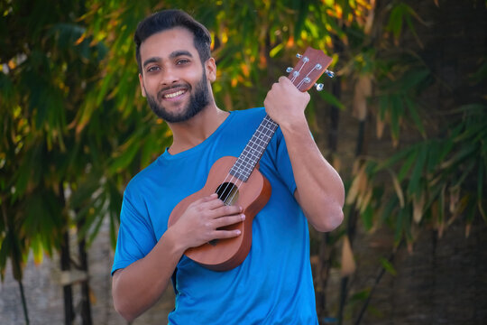 boy with ukulele a musical instrument Handsome Indian musician image