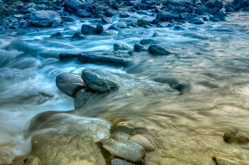 Beautiful Reshi River water flowing through stones and rocks at dawn, Sikkim, India. Reshi is one of the most famous rivers of Sikkim flowing through the state and serving water to many local people.