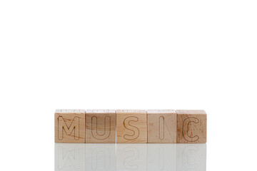 Wooden cubes with letters music on a white background
