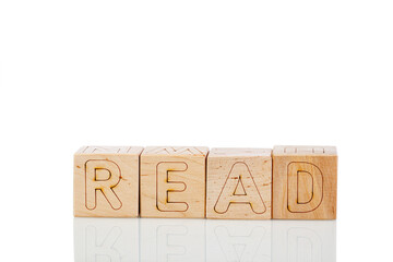 Wooden cubes with letters read on a white background