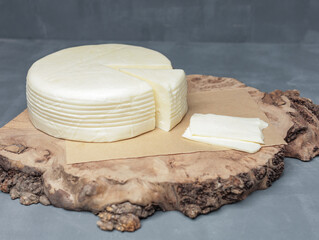 farm cheese on wooden stand on gray background - 478158457