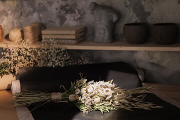 Obraz na płótnie Canvas Bouquet of dried flowers in florist workshop 