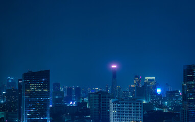 Nighttime in Bangkok city at night in Thailand. Aerial view of cityscape. Modern buildings, urban architecture.
