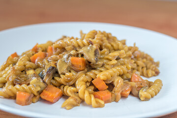 Pasta with cream sauce with forest mushrooms.