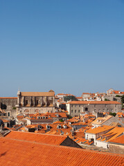 The city of Dubrovnik with its red roofed buildings and the blue sea in the background