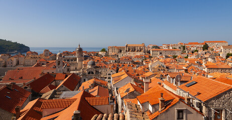 The city of Dubrovnik with its red roofed buildings and the blue sea in the background