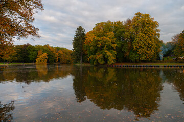 a park in fall with colourful trees and a lake
