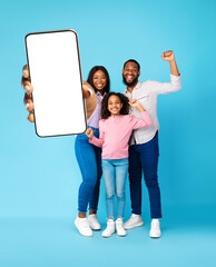 Black family showing empty smartphone screen and shaking fists