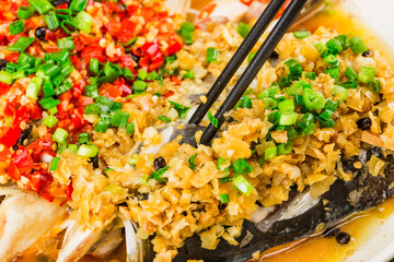 Steamed fish head with diced hot red peppers