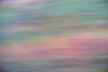 A colorful pattern. The picture is taken blurred by panning the camera. Rose hips on a rosebush.