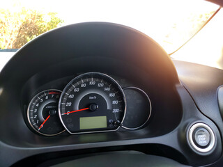 Close-up of the engine, the car's speedometer and the amount of fuel. Cheap oil concept. Hurry to...