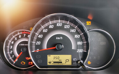 Close-up of the engine, the car's speedometer and the amount of fuel. Cheap oil concept. Hurry to...