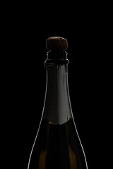 Champagne bottle with kork on black surface