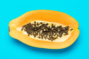 Papaya closeup on a blue background, top view, flat lay