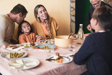 Happy latin family eating together at home on patio