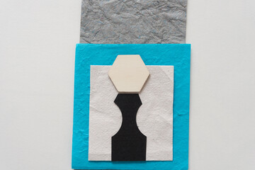 abstract composition with paper and wooden shape