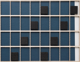 black tiles, grid, and blue paper