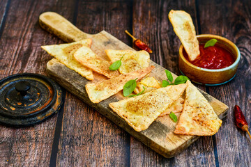  Home made ketogenic  Crispy nachos  tortilla chips with spicy red sauce. Mexican snack  for cinema.