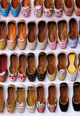 Colorful Handmade chappals (sandals) being sold in an Indian market, Handmade leather slippers, Traditional footwear.