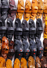 Colorful Handmade chappals (sandals) being sold in an Indian market, Handmade leather slippers, Traditional footwear.