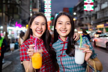 Asian woman in cheongsam dress with shopping bag. happy smiling woman holding colorful shopping bag in  china town.People traveling in city lifestyle at outdoor at China town street food market.