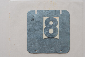 galvanized steel plate with the number eight on paper