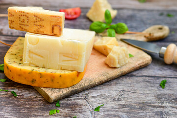  Set of different kinds ot delicious   Italian hard  cheeses,  cheese knives  and walnuts on wooden cheese board.Parmesan. Top view.