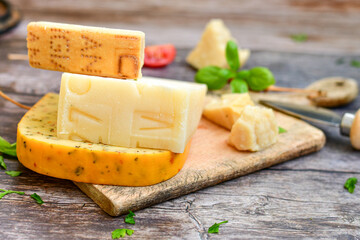  Set of different kinds ot delicious   Italian hard  cheeses,  cheese knives  and walnuts on wooden cheese board.Parmesan. Top view.