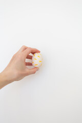 Girl holding Easter egg painted with watercolors in her hands, isolated on white background.