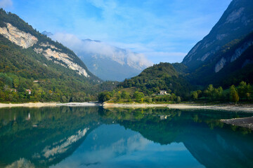 Fototapeta na wymiar Lago di Tenno with its clear turquoise water in the morning light. Trentino, Italy.