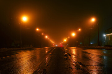 Night city road in fog, winter