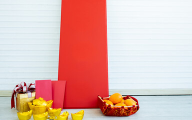 Objects of red envelopes with money for angpao, oranges, blank sign, golds, gift for celebrating Chinese New Year to present prosperity, wealth, healthy with copy space.