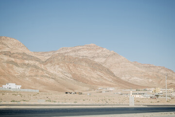 Deserted light mountains and blue sky. Landscape by the road. Jordan