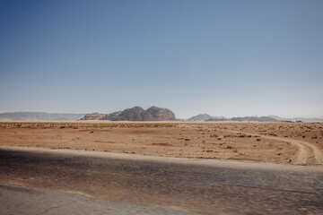 Deserted light mountains and blue sky. Landscape by the road. Jordan