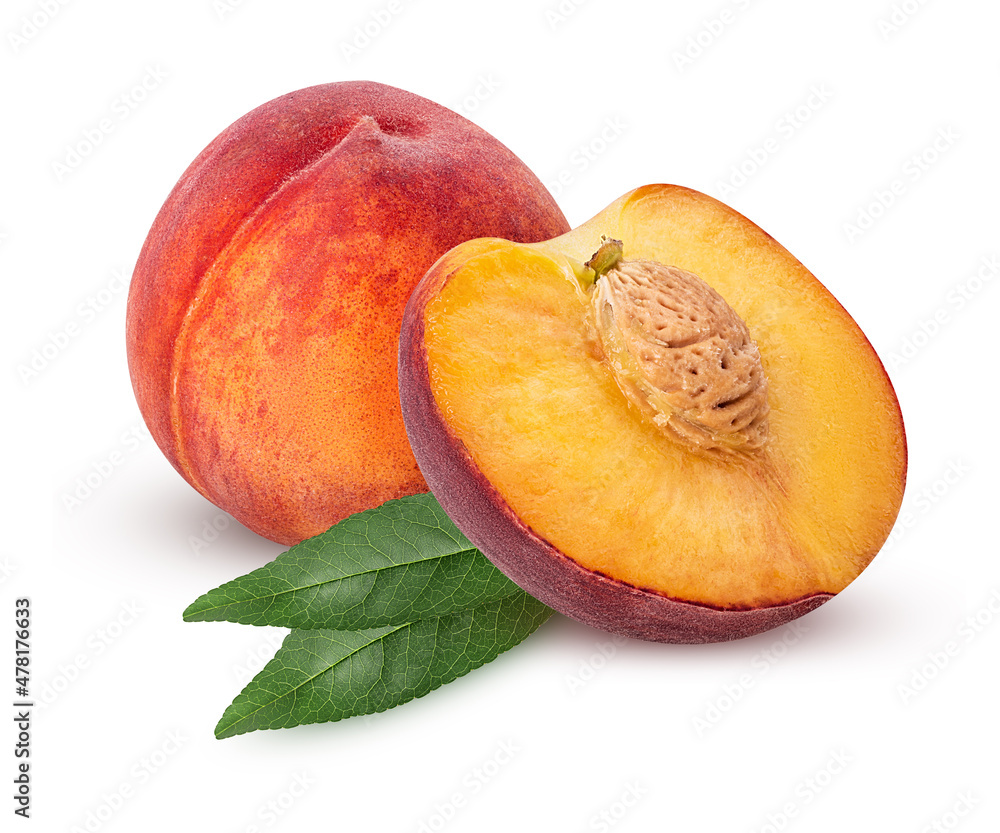 Wall mural Ripe peach fruit one cut in half with bone and green leaf