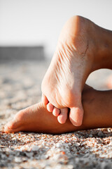 beautiful female feet in the beach sand