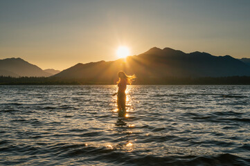 Female swimming in bikini during sunset at lake wenatchee