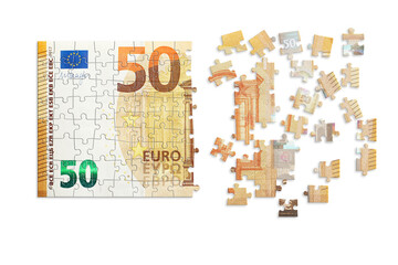 Puzzle made from fifty euro note and isolated on a white background.  Inflation and hyper inflation in Europe.