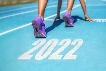 New Year resolution 2022 fitness weight loss challenge athlete woman running at race ready set go...