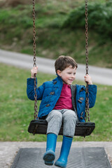 elementary child has fun on a swing set